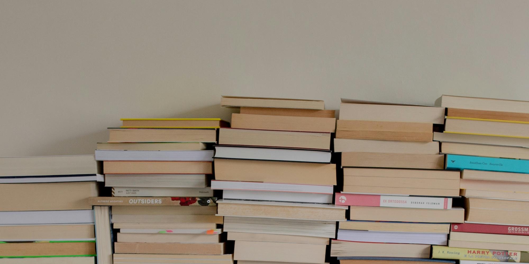 Cover image for this post: A stack of books, with covers facing away.